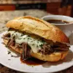 Crockpot French dip sandwiches served with dipping sauce