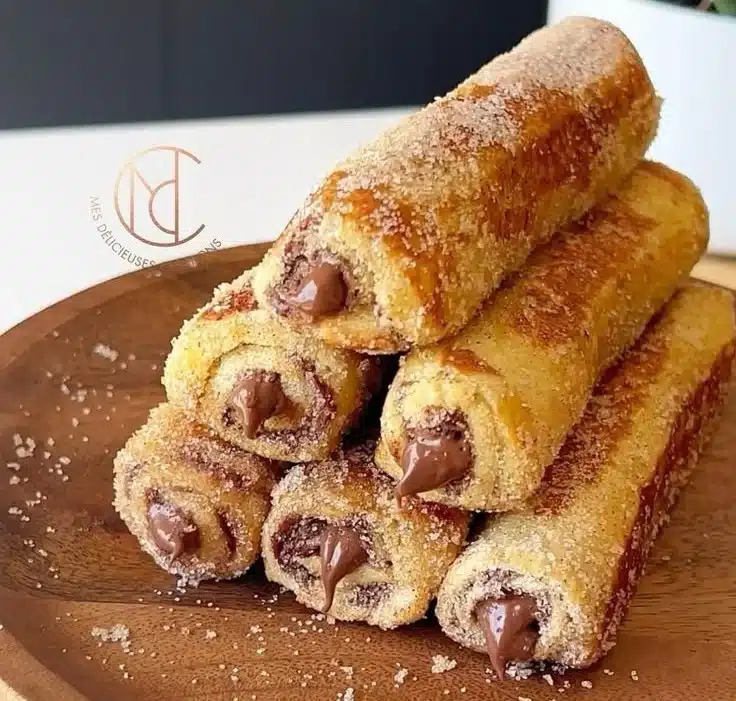 Delicious rolled French toast topped with syrup and berries