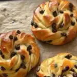 Vanilla Cream and Chocolate Chip Swirled Brioche loaf on a wooden board