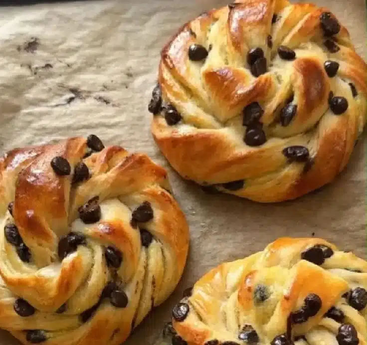 Vanilla Cream and Chocolate Chip Swirled Brioche loaf on a wooden board