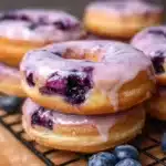 Freshly baked blueberry cake donuts topped with glaze