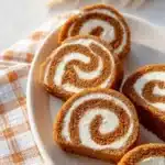 Delicious homemade carrot cake roll adorned with cream cheese frosting