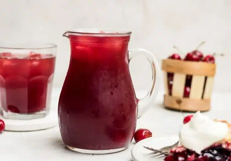 Delicious Cherry Pie Inspired Iced Tea served in a glass with cherries