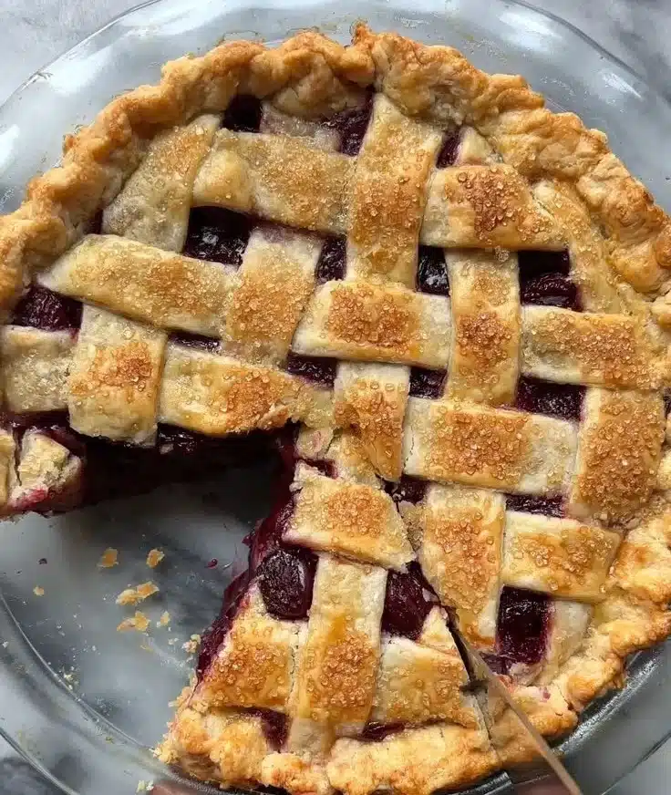 Delicious slice of classic cherry pie with fresh cherries and flaky crust