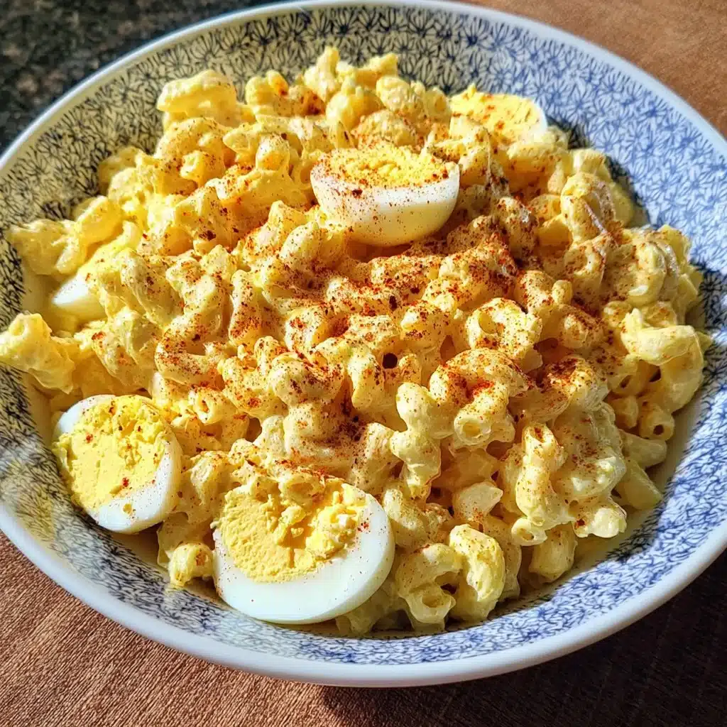 Deviled Egg Macaroni Salad served in a bowl with garnishes