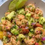 Fresh healthy shrimp avocado salad with tomatoes and greens