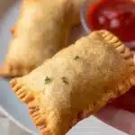 Homemade pepperoni pizza pockets, golden brown and stuffed with cheese and pepperoni