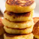 Cheesy leftover mashed potato pancakes served on a plate.