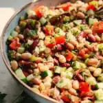 Colorful Mediterranean Bean Salad with mixed beans, vegetables, and dressing