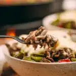 Delicious Philly cheesesteak bowls with beef, peppers, and onions.