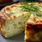 Slice of Zucchini Ricotta Cheesecake garnished with mint leaves