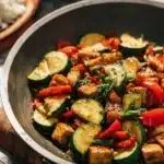 Colorful zucchini stir fry with fresh vegetables in a skillet