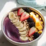 Delicious and vibrant acai bowl topped with fresh fruits and granola