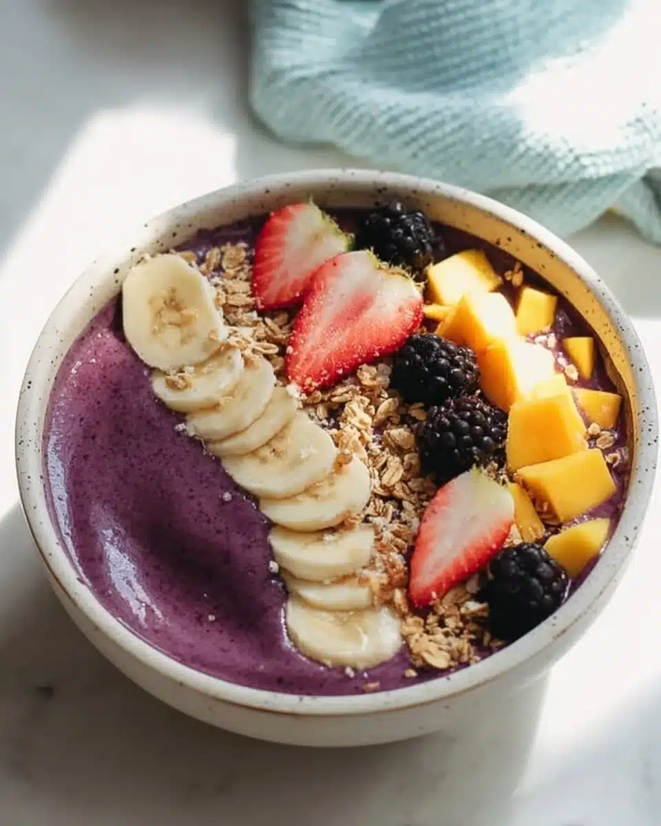 Delicious and vibrant acai bowl topped with fresh fruits and granola