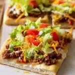 Best Crescent Roll Taco Pizza topped with fresh ingredients and cheese