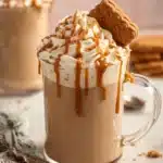 Biscoff Cookie Butter Latte garnished with a cinnamon stick and whipped cream