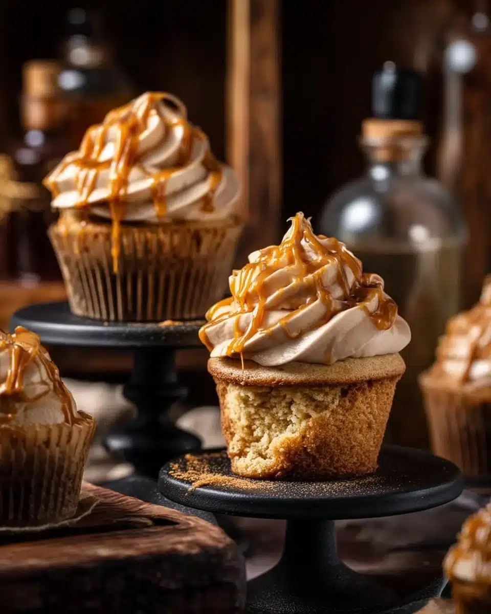Delicious Butterbeer Cupcakes topped with creamy foam frosting.