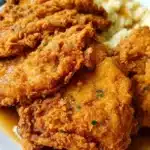 Delicious country fried chicken breast served with sides