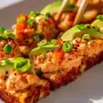 Delicious crispy rice salmon served on a white plate for a gourmet meal.