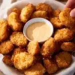 Plate of easy homemade chicken nuggets with dipping sauce and parsley