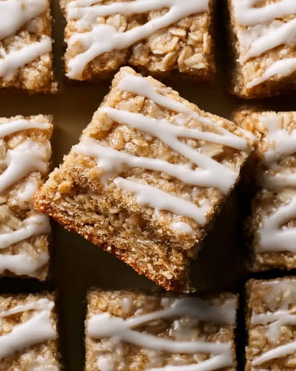 Delicious iced oatmeal cookie bars topped with creamy frosting and oats