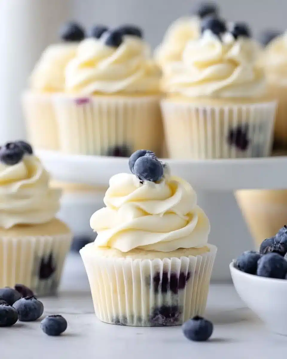 Lemon blueberry cupcakes topped with luscious frosting and fresh blueberries