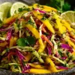 Colorful bowl of fresh Mango Slaw with vibrant vegetables and dressing
