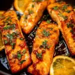 Delicious orange glazed salmon fillet garnished with herbs