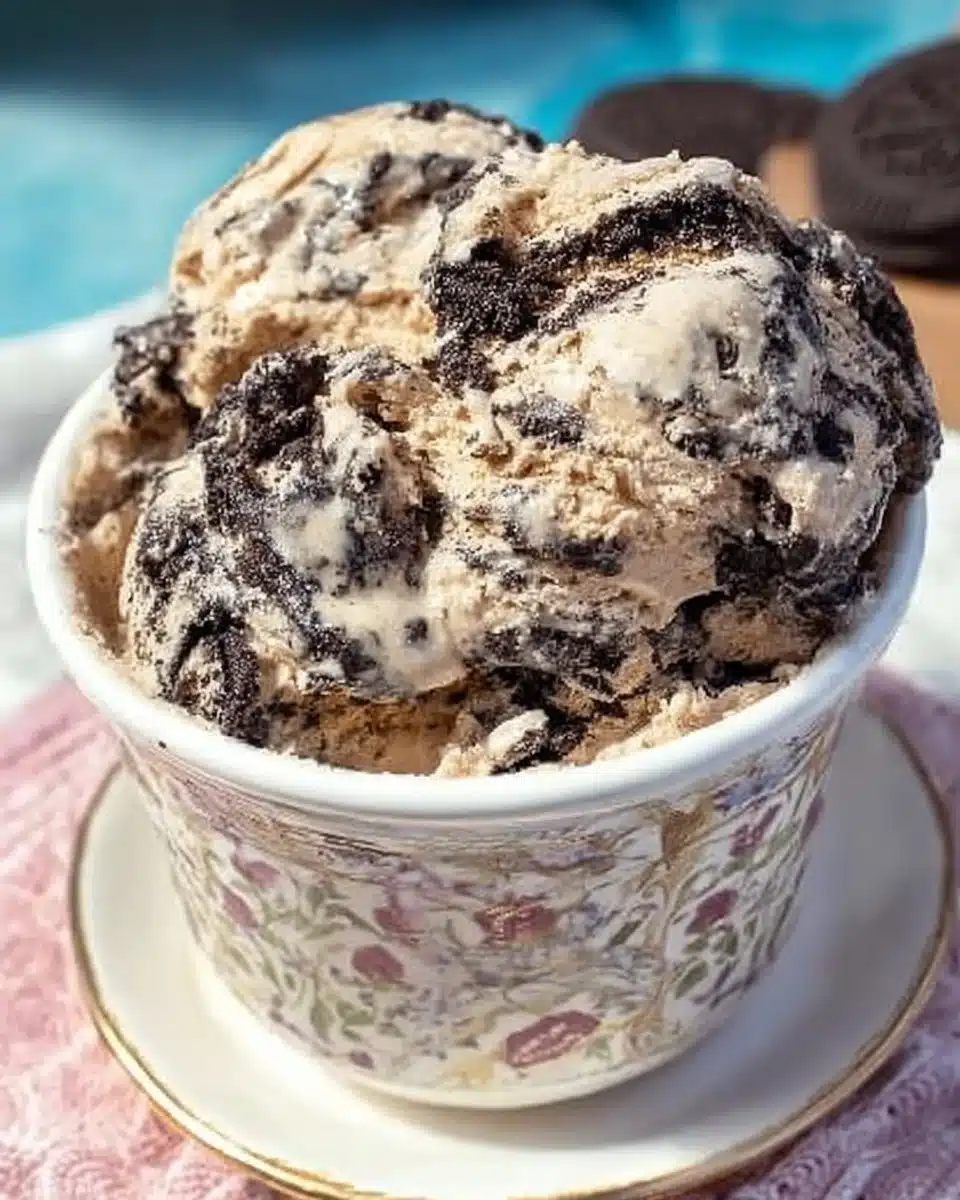 Bowl of Oreo Fudge Cappuccino Ice Cream topped with chocolate drizzle and cookie crumbles