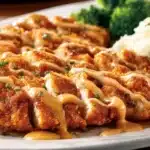 Delicious Outback Steakhouse Bloomin Fried Chicken served with sides