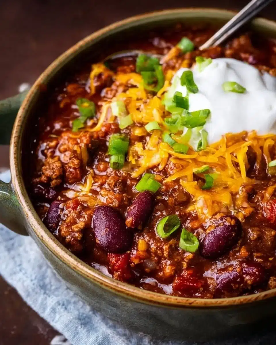 Homemade chili served in a bowl with toppings.