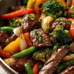 Bowl of beef stir fry with colorful vegetables