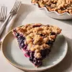Delicious blueberry crumble pie with a golden crust and fresh blueberries on top
