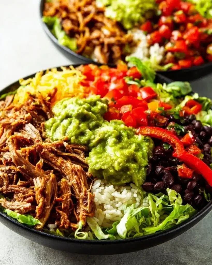 Delicious carnitas burrito bowl packed with pork, rice, and fresh toppings