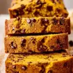 Loaf of homemade pumpkin chocolate chip bread with chocolate chips on top.