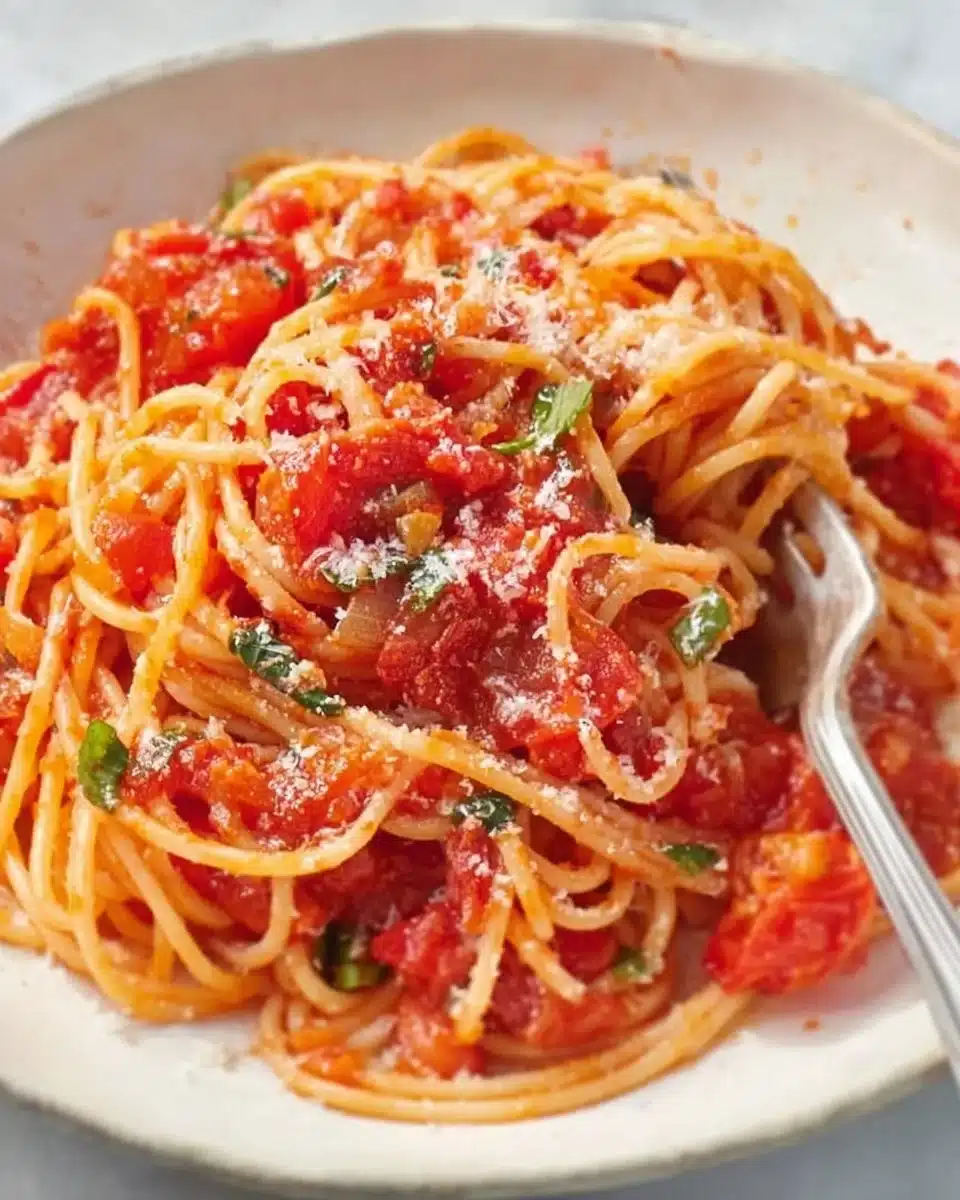 Delicious bowl of Neapolitan pasta topped with fresh ingredients.
