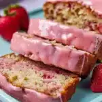 Freshly baked strawberry banana bread loaf with strawberries and bananas