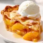 Delicious homemade peach pie with fresh peaches and flaky crust