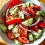 Delicious tomato cucumber salad with fresh ingredients in a bowl